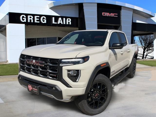 2026 GMC Canyon AT4 in Coastal Dune — front three-quarter view